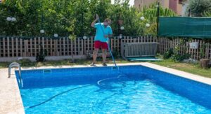 A person cleaning a pool